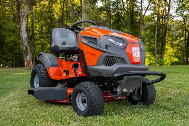 A riding lawn mower on a lawn preparing to mow.